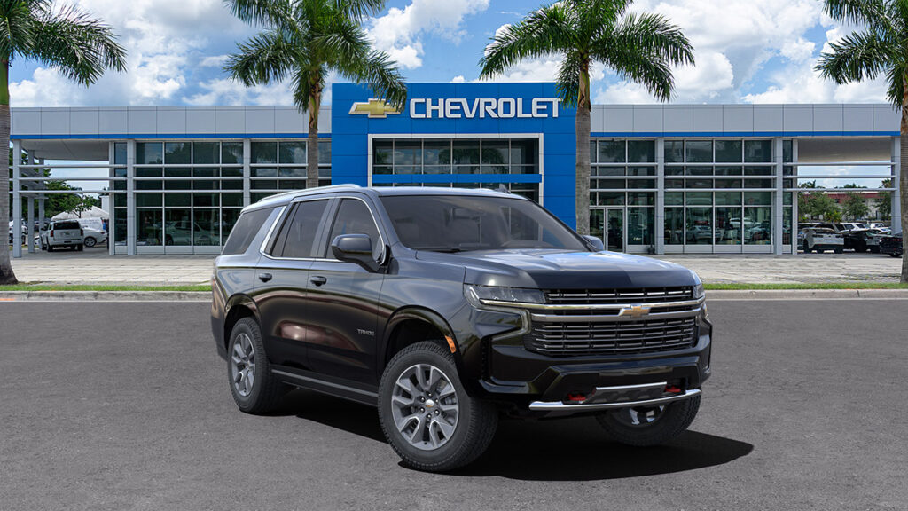 eVN AutoGraph image of a Chevy Tahoe for sale in front of a custom dealership background